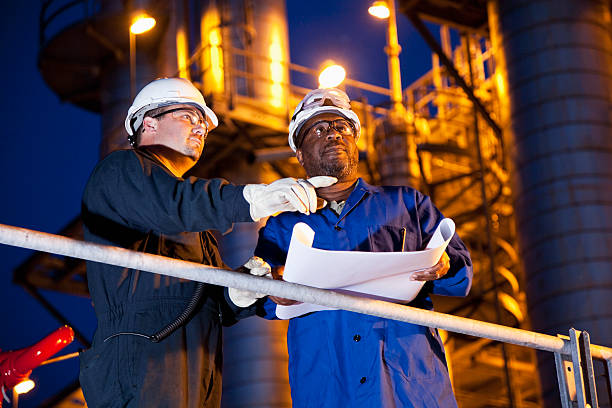 A photo of engineers working in front of an industrial plant